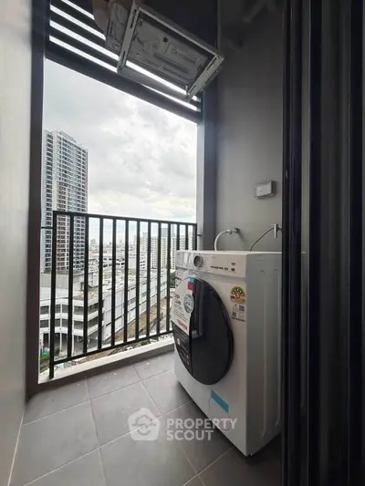 Modern high-rise balcony with washing machine and city view, perfect for urban living.
