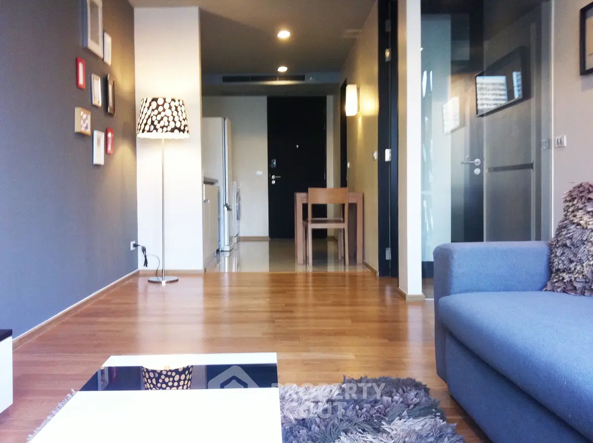 Modern living room with stylish decor and wooden flooring in a contemporary apartment.