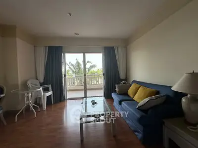 Spacious living room with balcony view and stylish furniture
