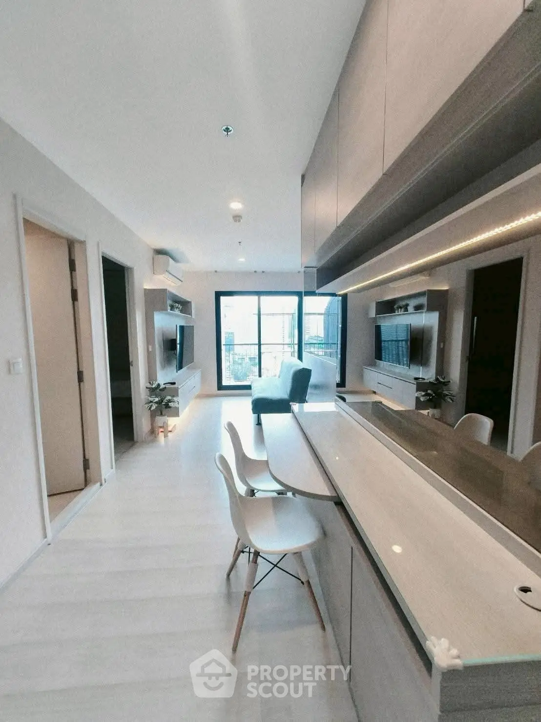 Modern open-plan living room with sleek kitchen and stylish decor