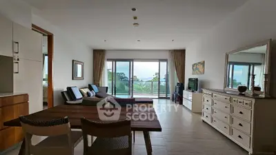 Spacious living room with modern decor and stunning balcony view