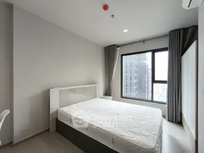 Modern bedroom with large window and minimalist design in urban apartment