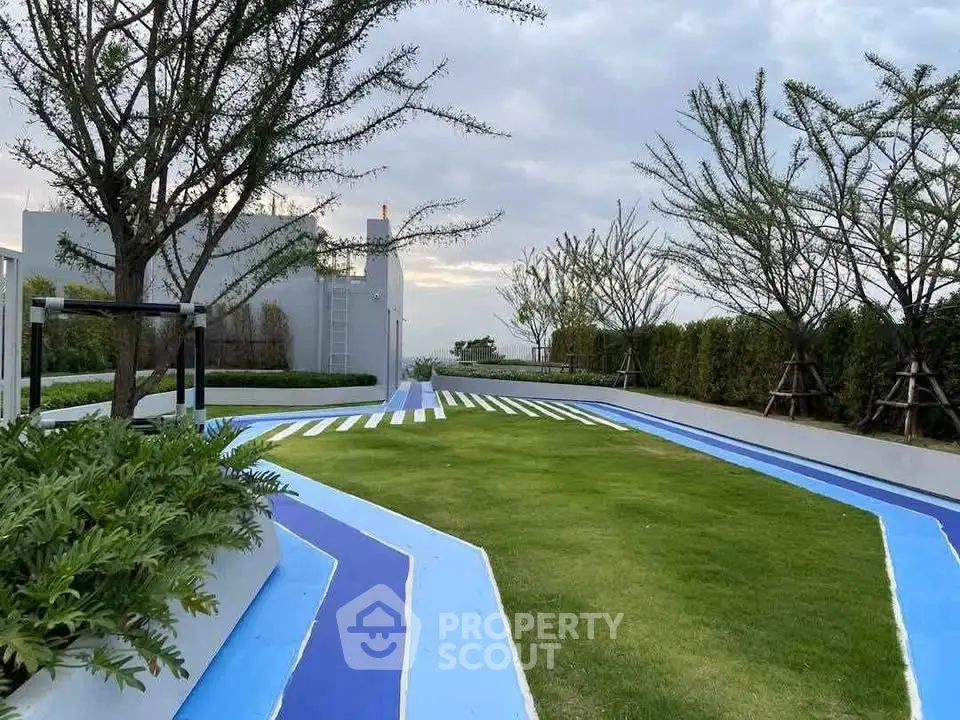 Modern rooftop garden with vibrant blue pathways and lush greenery