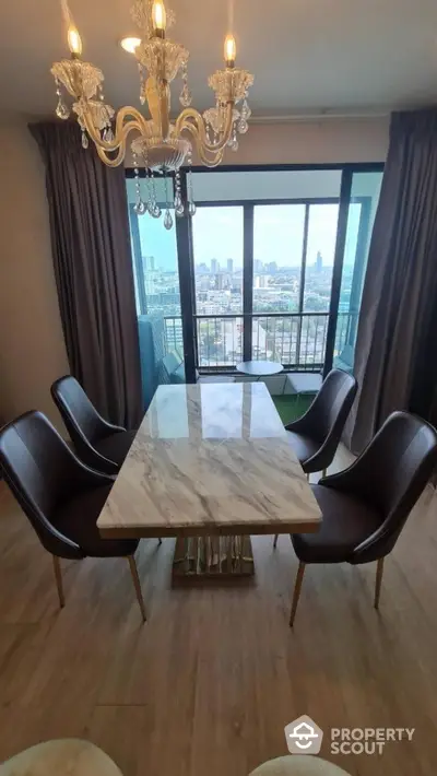 Elegant dining area with marble table and city view balcony in modern apartment