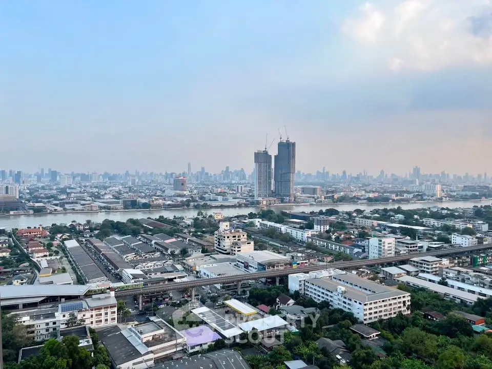 Stunning cityscape view with high-rise buildings and river, perfect for urban living.