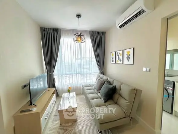 Modern living room with stylish decor, featuring a cozy sofa, wall art, and a sleek TV setup.