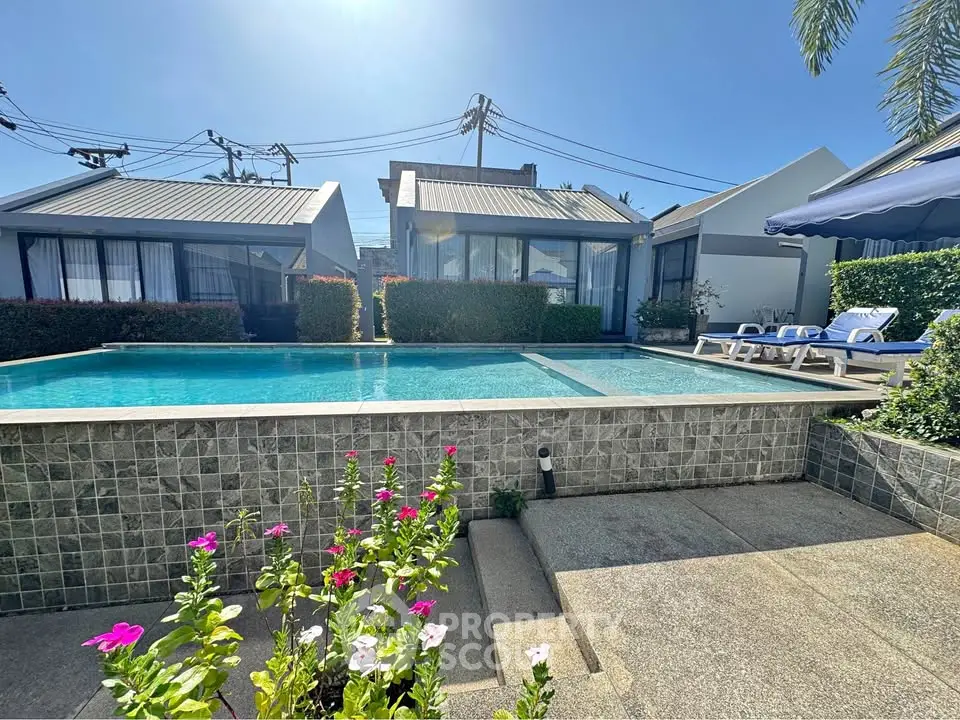Stunning modern home with a sparkling pool and lush garden, perfect for relaxation and entertainment.
