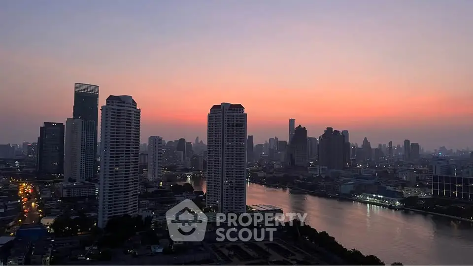Stunning cityscape view at sunset with river and skyscrapers, perfect for urban living enthusiasts.