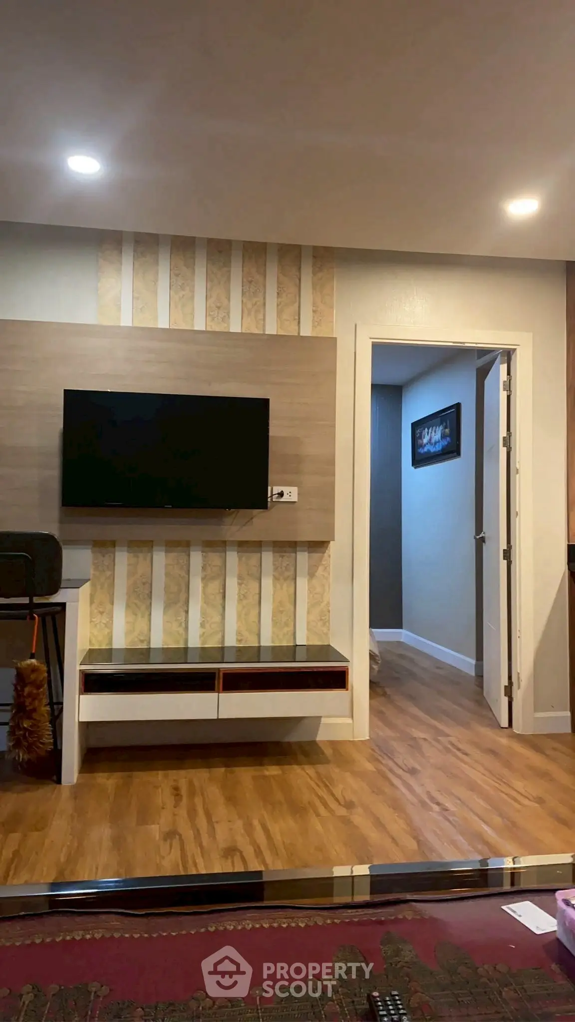 Modern living room with wall-mounted TV and stylish decor