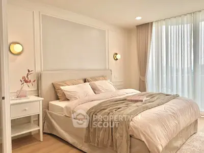 Luxurious bedroom with elegant decor and natural light, featuring a cozy bed and stylish lighting.