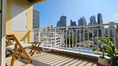 Spacious balcony with city skyline view, perfect for relaxation and enjoying urban living.