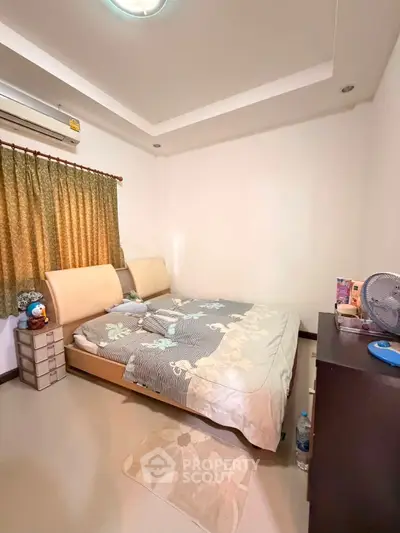 Cozy bedroom with modern decor and ample natural light, featuring a comfortable bed and stylish furnishings.