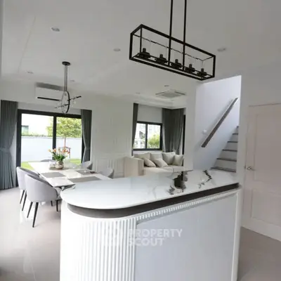 Modern open-concept living room with stylish kitchen island and elegant dining area.