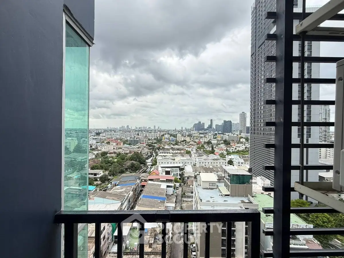 Stunning cityscape view from a high-rise balcony with modern architecture.