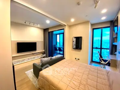 Modern bedroom with city view, featuring a cozy bed, TV, and workspace.