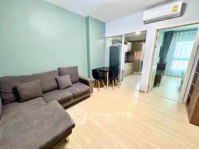 Modern living room with cozy sofa and open kitchen in stylish apartment