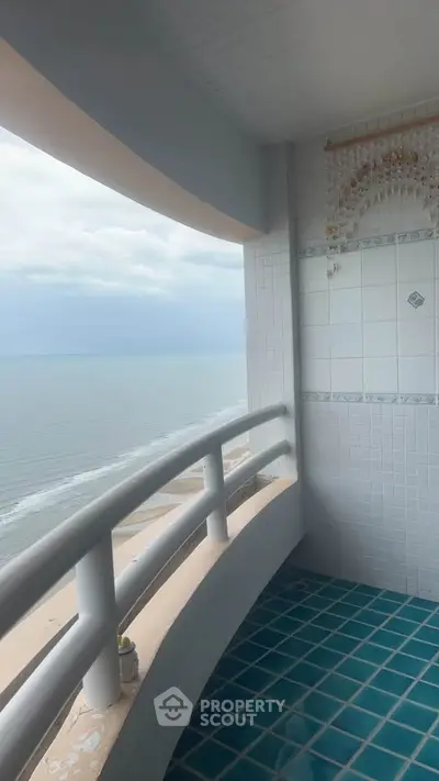 Stunning ocean view from a tiled balcony, perfect for relaxation.