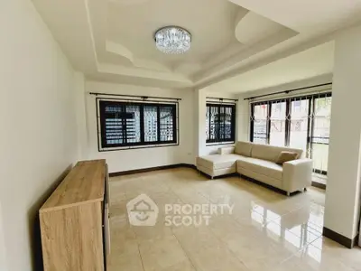 Spacious living room with elegant ceiling design and large windows for natural light.