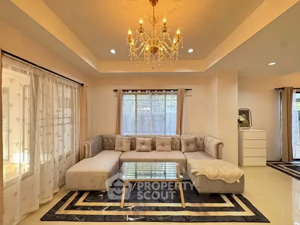 Luxurious living room with elegant chandelier and plush sectional sofa