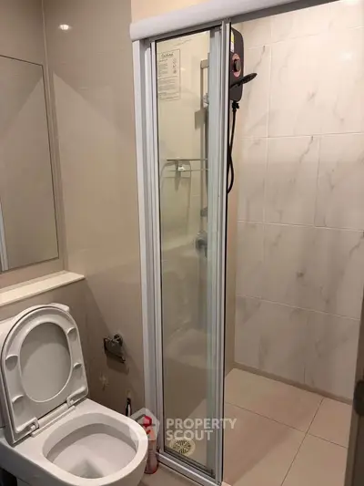 Modern bathroom with shower and toilet in sleek design