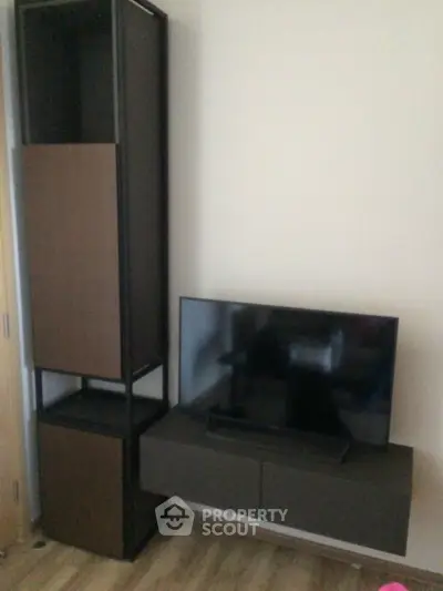 Modern living room with sleek TV stand and tall storage unit, perfect for stylish urban living.