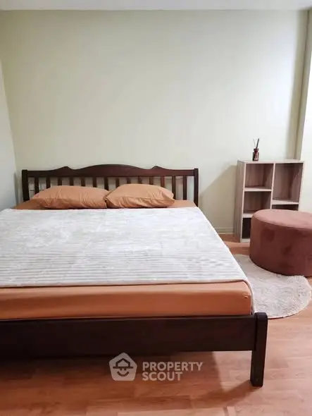 Cozy bedroom with wooden bed frame and modern decor