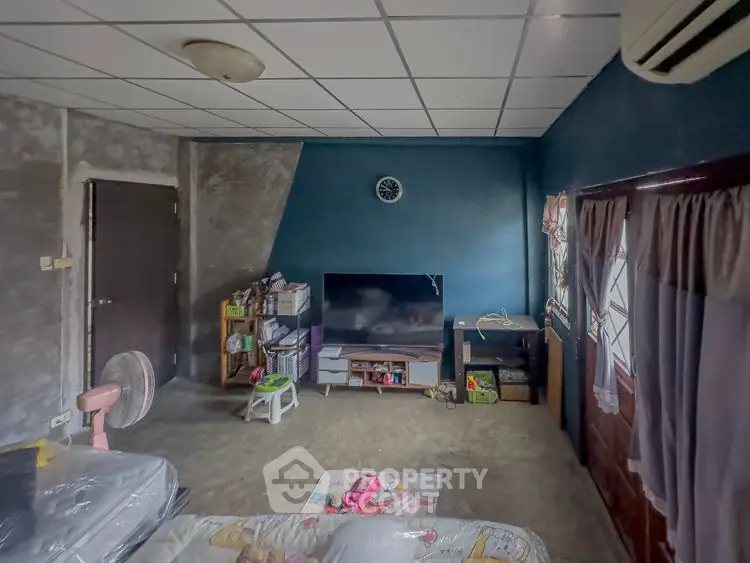 Cozy living room with TV, air conditioning, and modern decor in a stylish home.