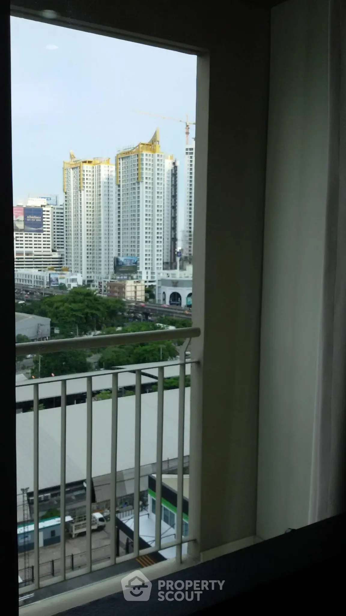 Stunning city view from a high-rise apartment balcony, showcasing urban living at its finest.