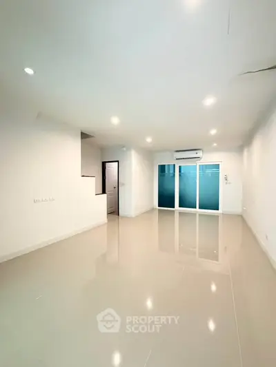 Spacious modern living room with sleek tiled flooring and air conditioning