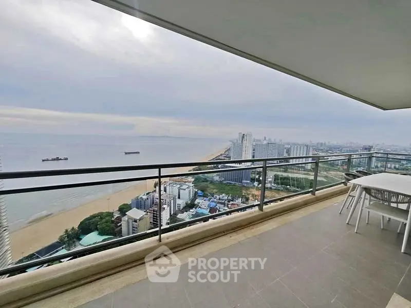 Stunning high-rise balcony with panoramic ocean views and modern outdoor seating.