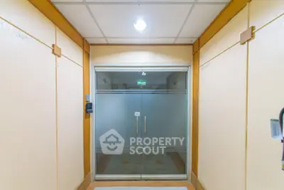 Modern building entrance with glass doors and bright lighting