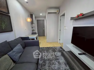 Modern living room with cozy sofa, stylish decor, and flat-screen TV in a contemporary apartment.