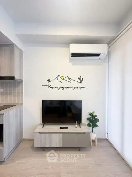 Modern living room with stylish decor, wall art, and air conditioning unit.