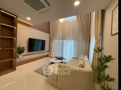 Luxurious modern living room with high ceilings and elegant decor, perfect for relaxation and entertainment.