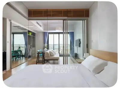 Modern bedroom with mirrored closet and balcony view in stylish apartment