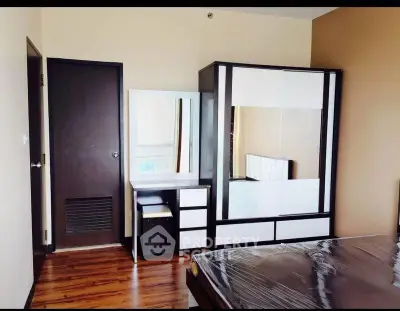 Modern bedroom with sleek furniture and wooden flooring, perfect for stylish living.