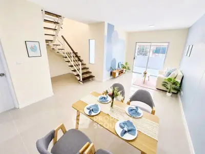 Modern open-plan living and dining area with stylish decor and natural light.