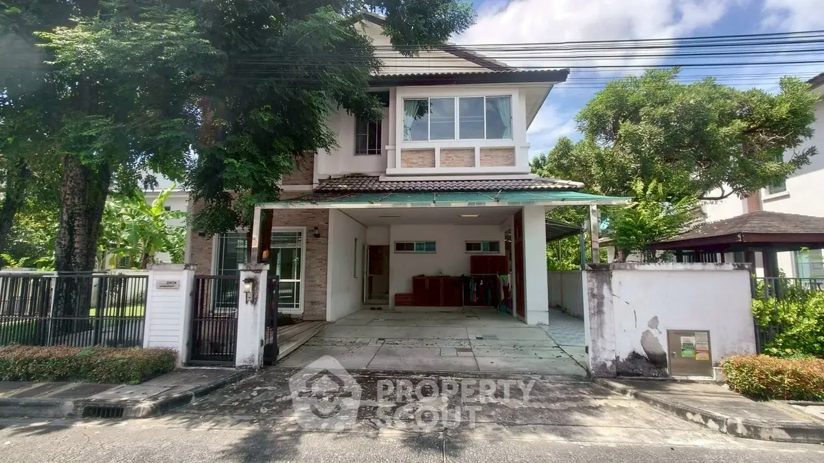 Charming two-story house with spacious driveway and lush greenery