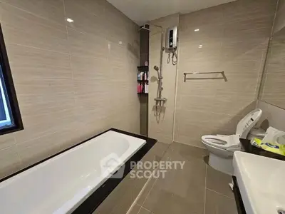 Modern bathroom with bathtub and sleek tile design