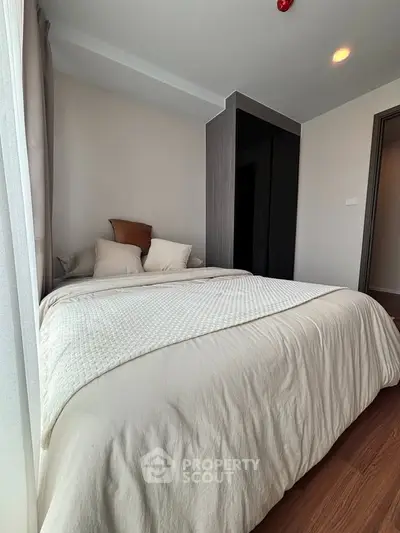 Cozy bedroom with modern decor and ample natural light