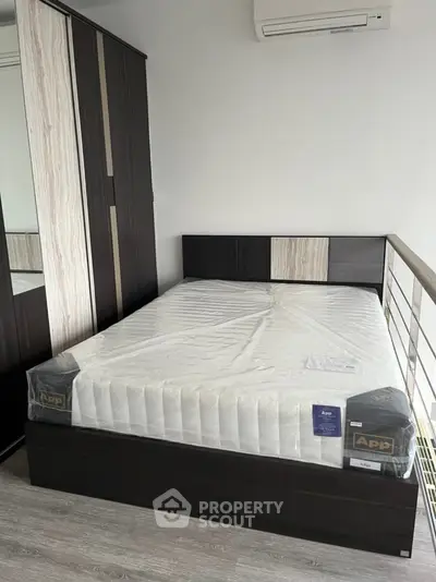 Modern bedroom with sleek design and air conditioning, featuring a new mattress and stylish wardrobe.