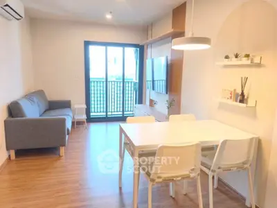 Modern living room with stylish decor and balcony access in a cozy apartment.