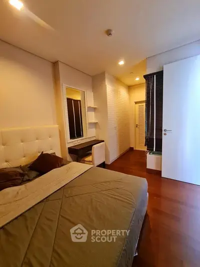 Cozy bedroom with elegant wooden flooring and modern furnishings