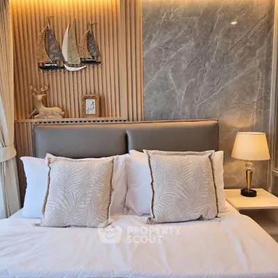 Luxurious bedroom with elegant decor and plush bedding in modern apartment.