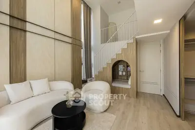 Modern living room with stylish furniture and unique staircase design