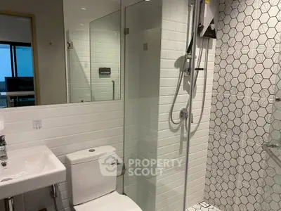 Modern bathroom with stylish tiles and glass shower enclosure