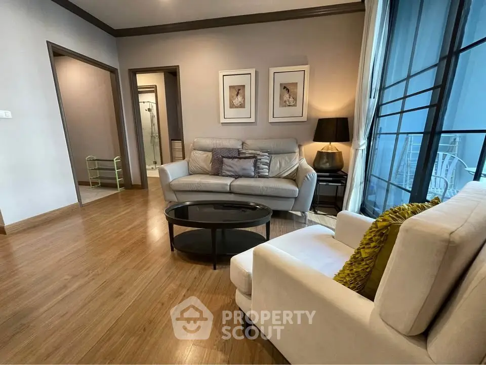 Spacious living room with modern decor and large windows for natural light.