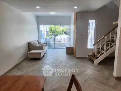 Spacious living room with modern design and large windows for natural light.