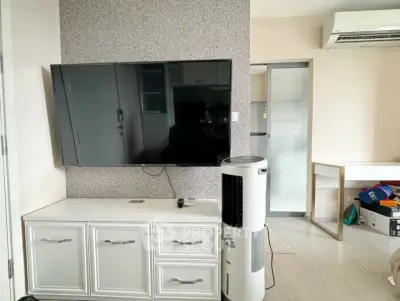 Modern living room with wall-mounted TV and air conditioning unit
