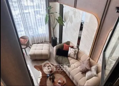 Luxurious modern living room with stylish furniture and large windows